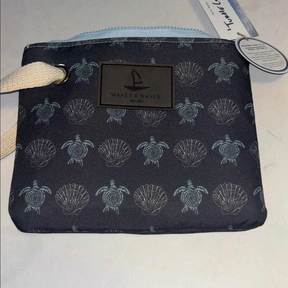 WAKES & WAVES BLUE WRISTLET WITH TURTLE DESIGN WATERPROOF CANVAS LIKE MATERIAL